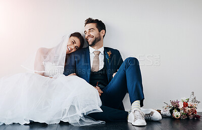 Buy stock photo Couple, wedding and church with smile, happy and sitting on floor after marriage ceremony and event. Celebration, love and happy people with laugh of bride with funny joke and commitment together