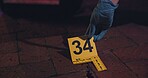 Evidence marker, hand of csi and crime scene with forensic on floor at night for investigation of murder. Professional, expert in gloves and case investigator with observation and search with blood