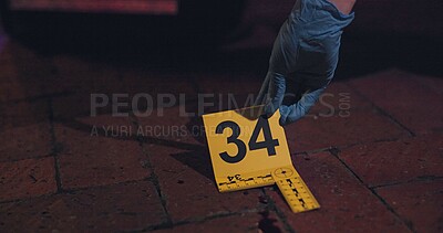 Evidence marker, hand of csi and crime scene with forensic on floor at night for investigation of murder. Professional, expert in gloves and case investigator with observation and search with blood