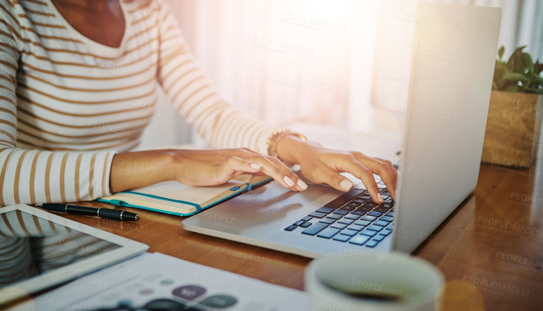 Buy stock photo Closeup shot of an unrecognizable woman working on a laptop at home