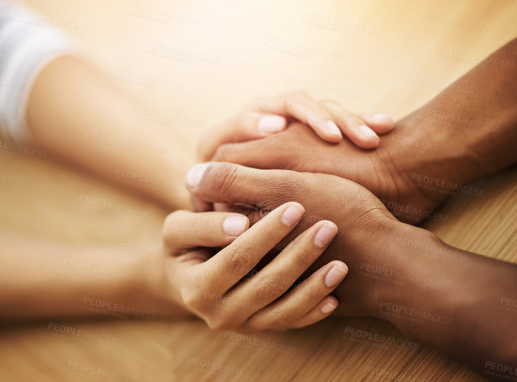 Buy stock photo People, holding hands and support in home with empathy, trust and grief counseling for mental health. Friends, love and gesture at table for hope, solidarity and relationship development for healing