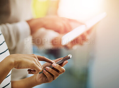 Buy stock photo Cropped shot of two unrecognizable businesspeople browsing on a phone and digital tablet