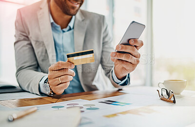 Buy stock photo Closeup shot of an unrecognizable businessman using a cellphone while holding a credit card in an office