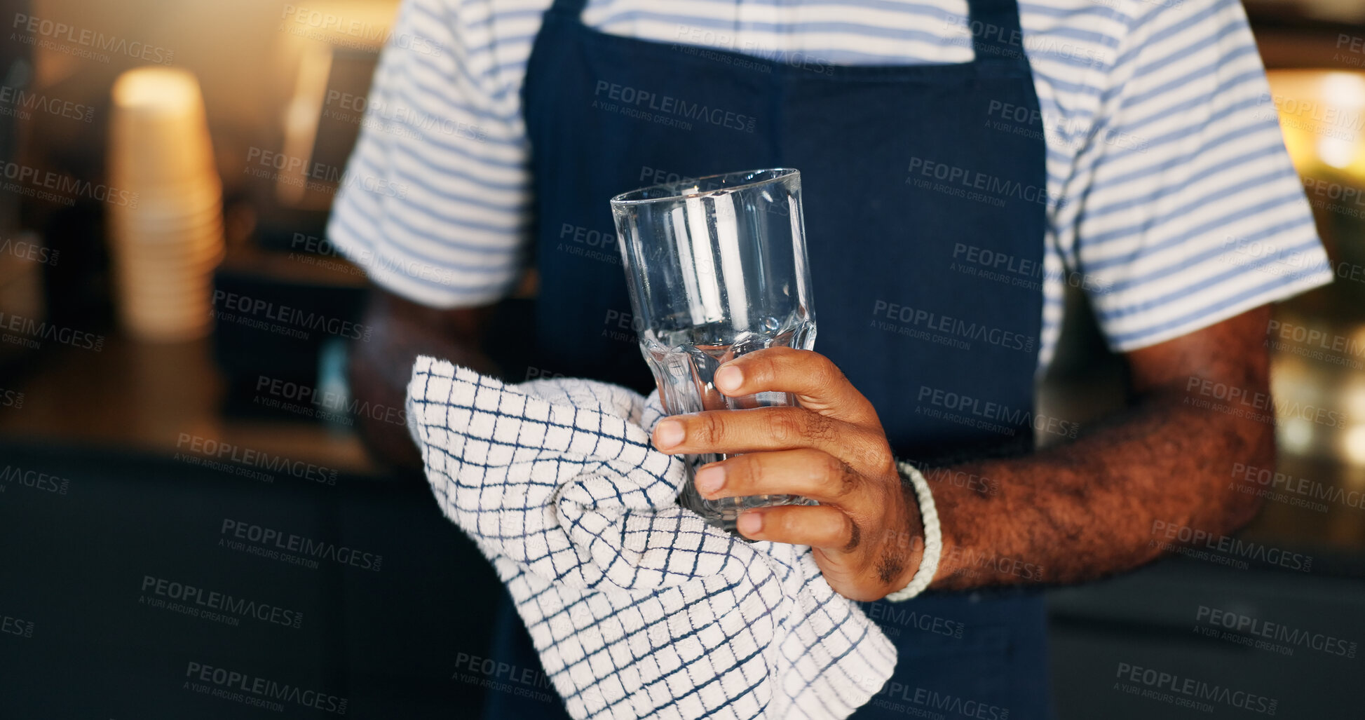 Buy stock photo Hands, waiter and cleaning a glass in restaurant for dust, dirt or bacteria with maintenance and workflow. Barista, man and cleaner in cafe, coffee shop or small business for disinfection and hygiene