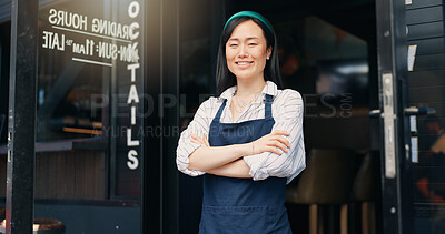 Happy asian woman, cafe and owner by door of small business in confidence for management. Portrait of young female person or waitress smile with arms crossed by professional restaurant or coffee shop