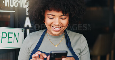 Black woman, phone and open cafe by door for communication, social media or networking. Happy African female person or waitress smile on mobile smartphone in online chatting or texting at coffee shop