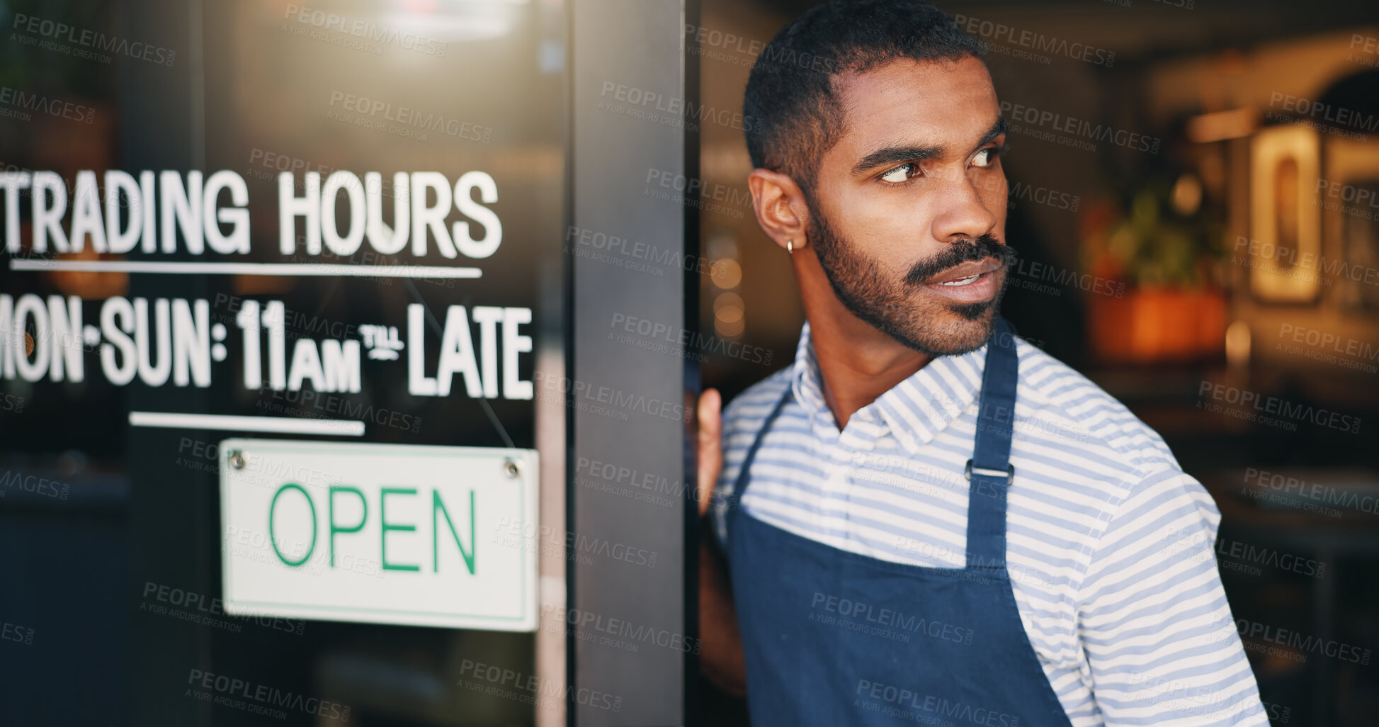 Buy stock photo Man, coffee shop and open sign on front door with waiting for customer, thinking and service in morning. Waiter, server or small business owner at cafeteria with board for welcome to store for drink