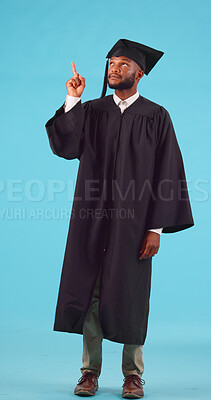 College student, pointing and graduation space in studio for future scholarship. Portrait, advertising and unsure black male show marketing for university choice, doubt or decision on blue background