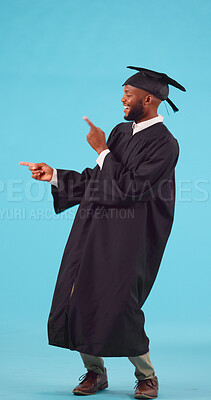 Marketing, graduation and male student in a studio showing a promotion or advertisement. Happy, smile and young African man graduate with a presentation hand gesture isolated by a blue background.