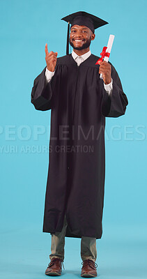 Marketing, pointing and male graduate with a diploma in studio for achievement, success or goal. Graduation, advertising and portrait of African man university student with degree by blue background.