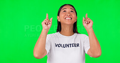Face, woman or volunteer pointing up, green screen or announcement against a studio background. Portrait, female person or model with mockup space, charity or npo with humanitarian or problem solving