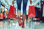 Woman, walking and shopping bag with sale at mall for retail therapy, promotion and customer discount. Shoes, female person or shopper in Paris for holiday or vacation, purchase or spending in store