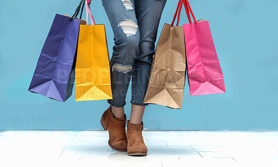 Shopping bag, studio and legs of woman with clothes for retail giveaway, sale or boutique discount. Female person, feet and customer with packaging for fashion, deal and commerce on blue background