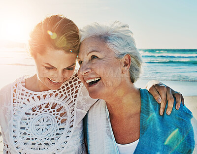 Buy stock photo Cropped shot of a senior woman and her adult daughter spending a day at the beach