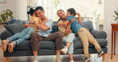 Family, hug and children with parents in a living room at home for comfort. Young kids run to a happy man and woman or mom and dad for fun, happiness and love while playing and bonding with care