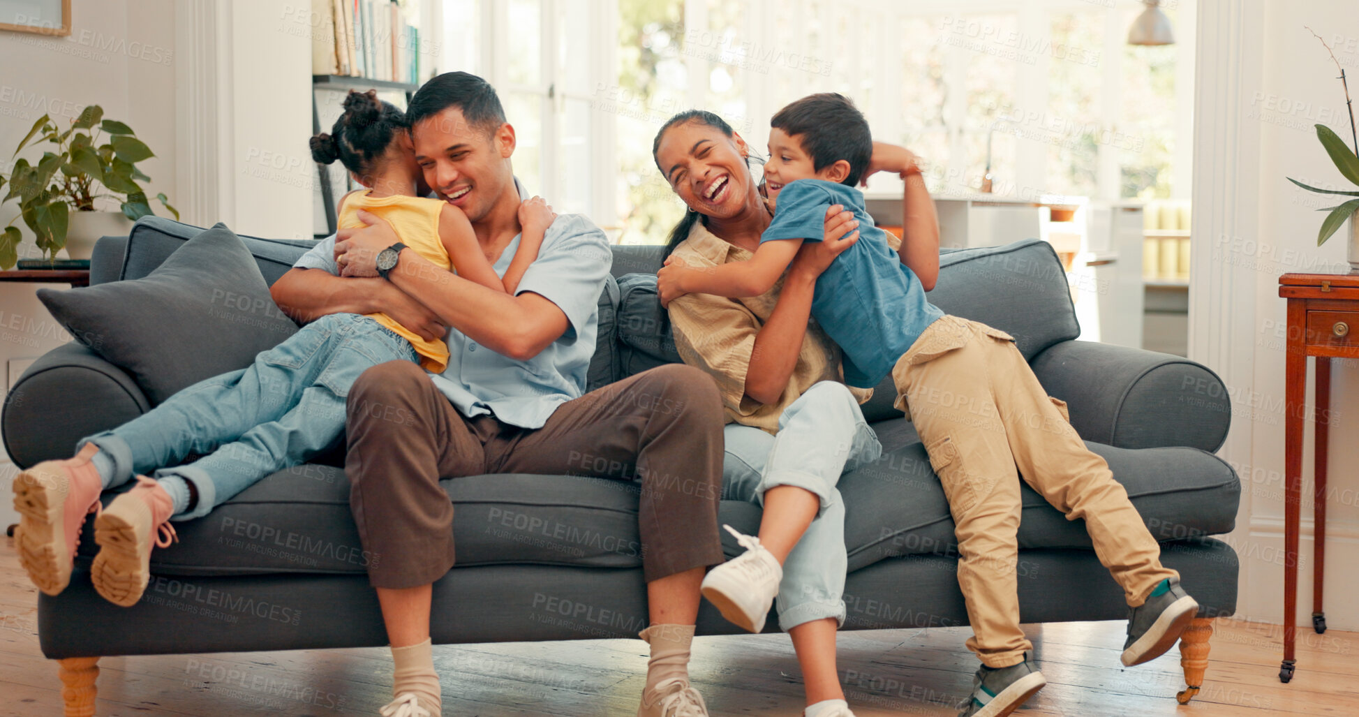 Buy stock photo Happy family, hug and love on a sofa with care, security and support, bonding and comfort at home. Safety, trust and children embrace parents in living room for weekend, vacation or house staycation 