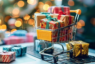 Christmas, shopping cart and miniature gifts on laptop for celebration, festive season or religious holiday. Closeup, presents and trolley on computer for xmas, surprise and wrapping paper with bokeh