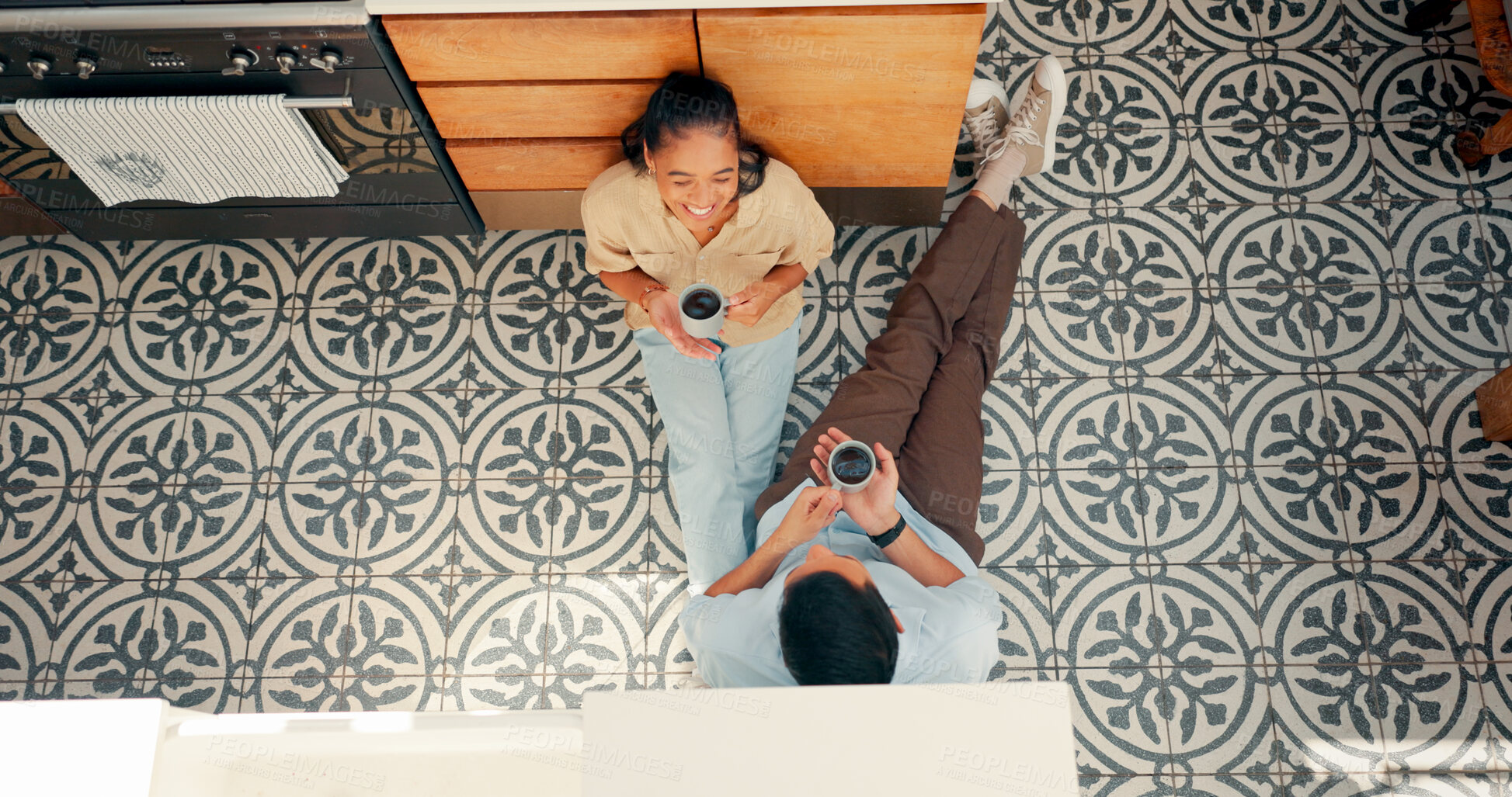 Buy stock photo Coffee, talking and a couple in a kitchen with love, care and communication at home. Laughing, woman and man drinking tea together for bonding and conversation and on a floor above with marriage