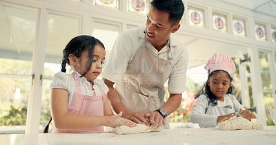 Baking, dough and a dad teaching his girls about cooking in the kitchen of their home together. Pastry, children or family with female kids learning about food from from a man parent in the house