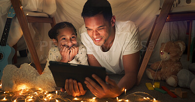 Tent, father and girl on tablet at night watching movies, online games and cartoon with fairy lights. Happy family, blanket and dad with child in bedroom on digital tech for bonding, relax and love