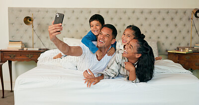 Phone, selfie and family together on bed for happy portrait, memory and social media post of bonding, quality time or weekend. Morning with dad, mom and children in bedroom waking up and relaxing