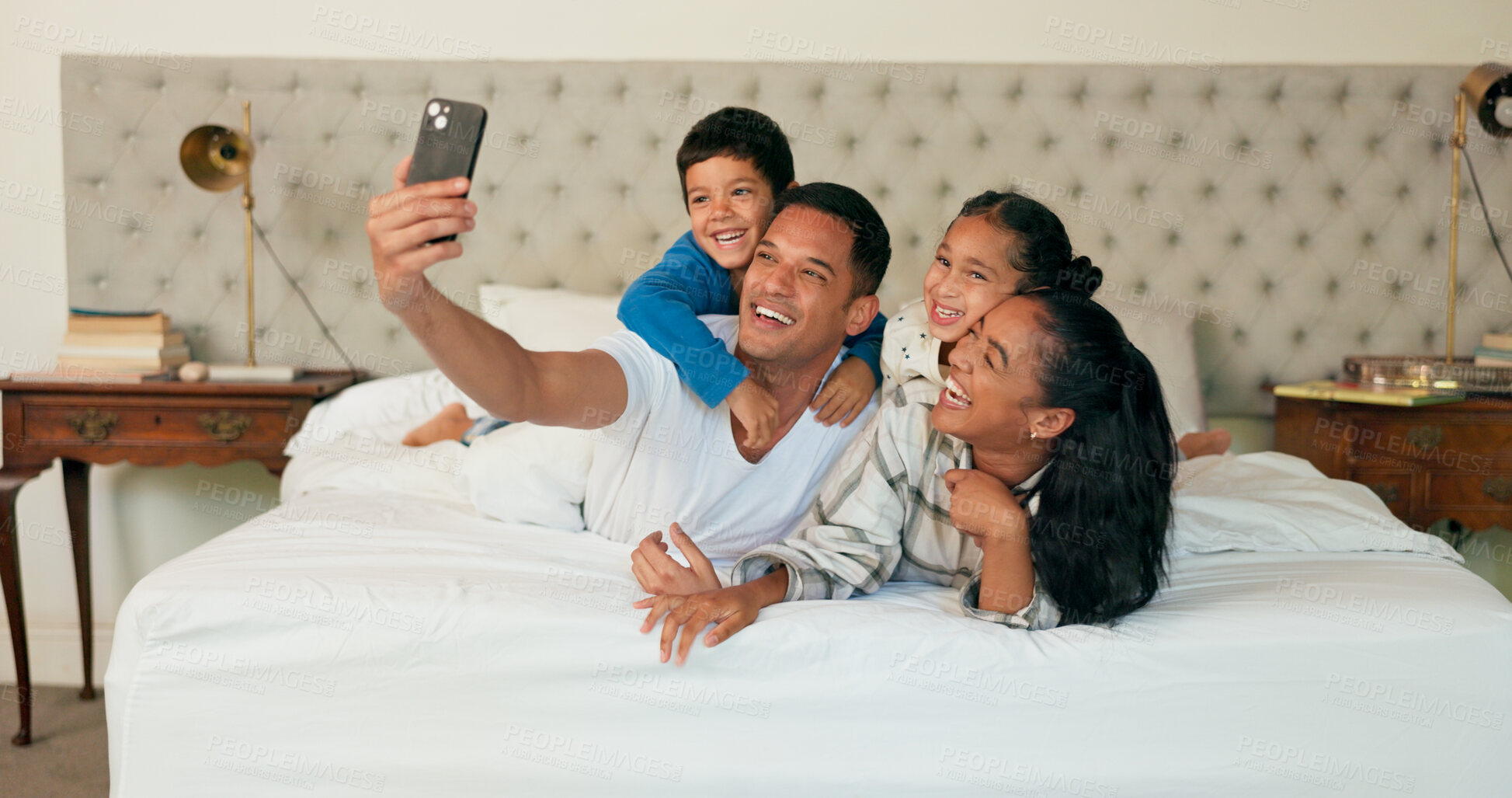 Buy stock photo Happy family, selfie and relax with picture on bed for memory, bonding or photography at home. Mother, father and young children with smile for playful morning, moment or weekend together in bedroom