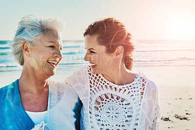 Buy stock photo Cropped shot of a senior woman and her adult daughter spending a day at the beach
