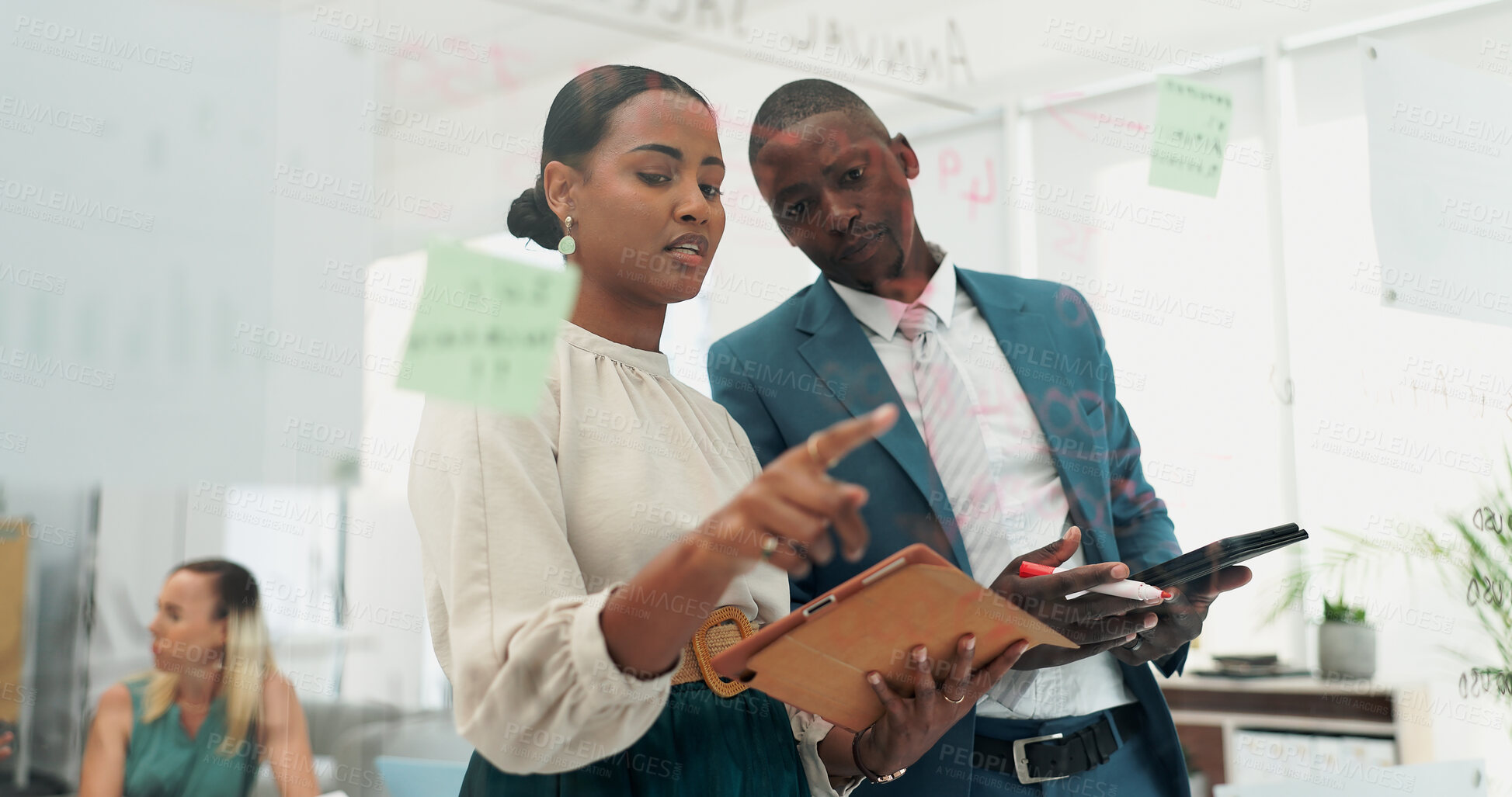 Buy stock photo Business man, woman and notes at glass with tablet, discussion and planning with teamwork in office. People, partnership and digital touchscreen by board with reading, thinking and creativity at job