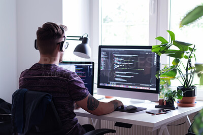 Man, computer and web designer in home for screen, programmer and cybersecurity for startup company. Male person, back and writing code on website or app, headphones and internet for cpu system