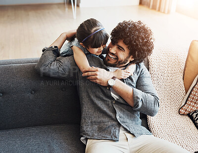 Buy stock photo Laughing, dad and girl with hug on sofa for love, appreciation and bonding together on weekend. Playful, family and man with embrace of daughter at home for gratitude, humor and safety in childhood