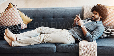 Buy stock photo Phone, rest and man on sofa in home happy for mortgage approval email for goal achievement. Banner, relax and male person laying on couch in living room with cellphone for communication online.