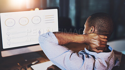 Buy stock photo Rearview shot of an unrecognizable young businessman experiencing tension while using a computer to look at graphs late at work