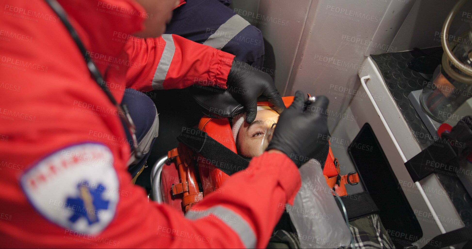 Buy stock photo Patient, paramedic and shine light into eyes to check pupil, test and first aid. Hands, medical professional and flashlight to woman, unconscious and rescue for health, emergency or help in ambulance