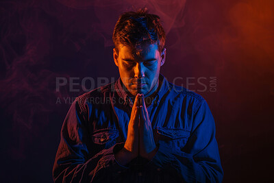 Faith, christian and praying man in red background with trust, hope and gratitude with prayer. Religion, male person and hands together to seek guidance, wisdom or blessings for personal growth