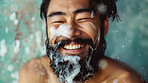 Face, skincare and soap with asian man in bathroom closeup for cleaning, hydration or hygiene. Beauty, water in shower and smile with happy person washing beard or skin for morning cleanse routine