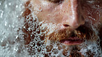 Bubbles, beard and man in bath for clean, health and skincare routine with body hygiene. Foam, mouth and closeup of male person with facial hair washing in water for wellness treatment at home.