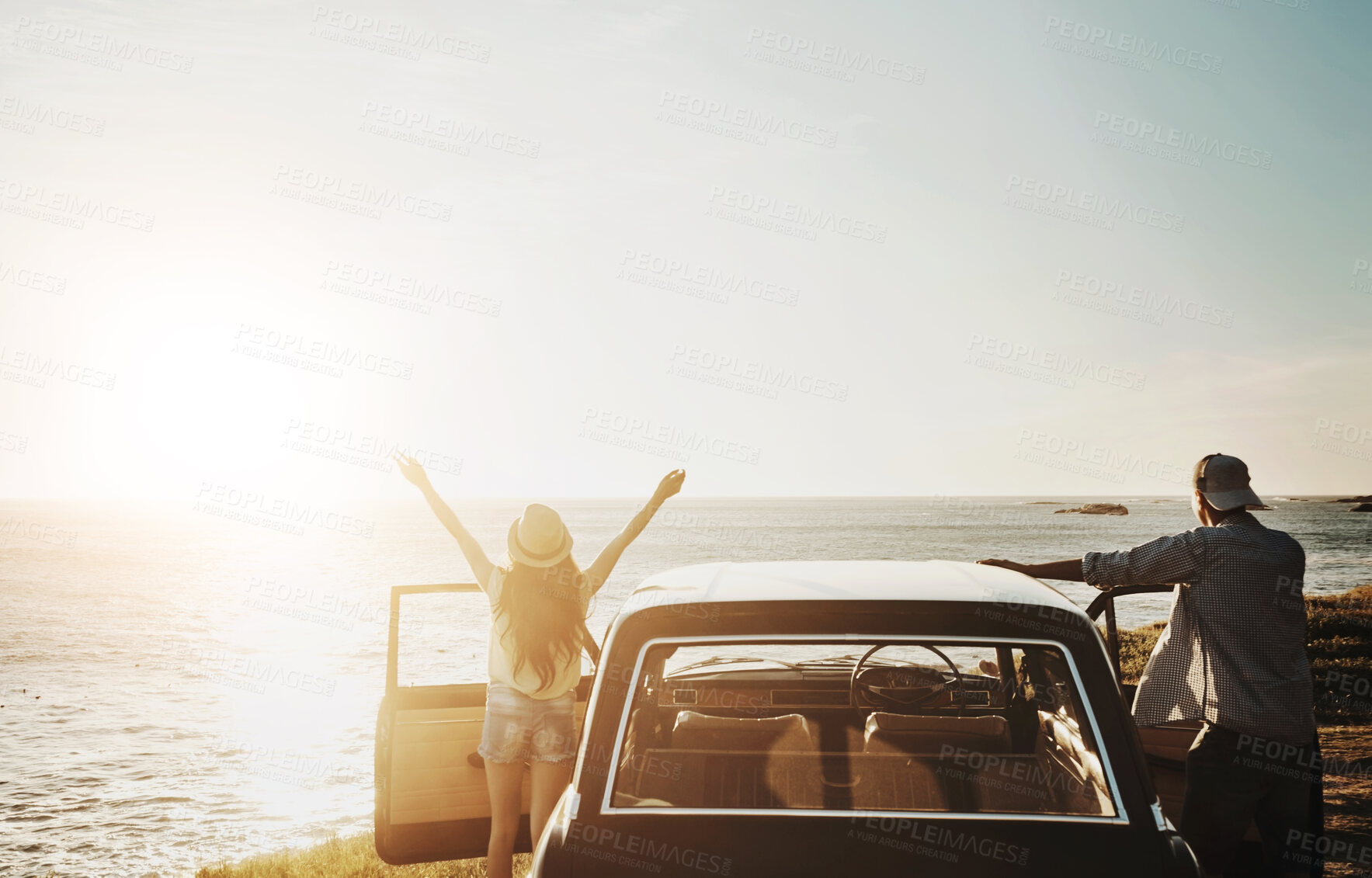 Buy stock photo Car, travel and couple with freedom at beach for summer holiday, anniversary and sunset in California. Journey, drive and people by ocean on road trip for tourism, romantic adventure and celebration