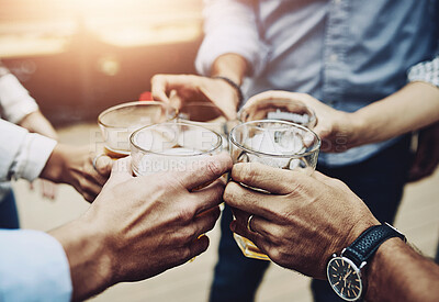 Buy stock photo Shot of a group of unrecognizable work colleagues having a celebratory toast together with beer outside during the day