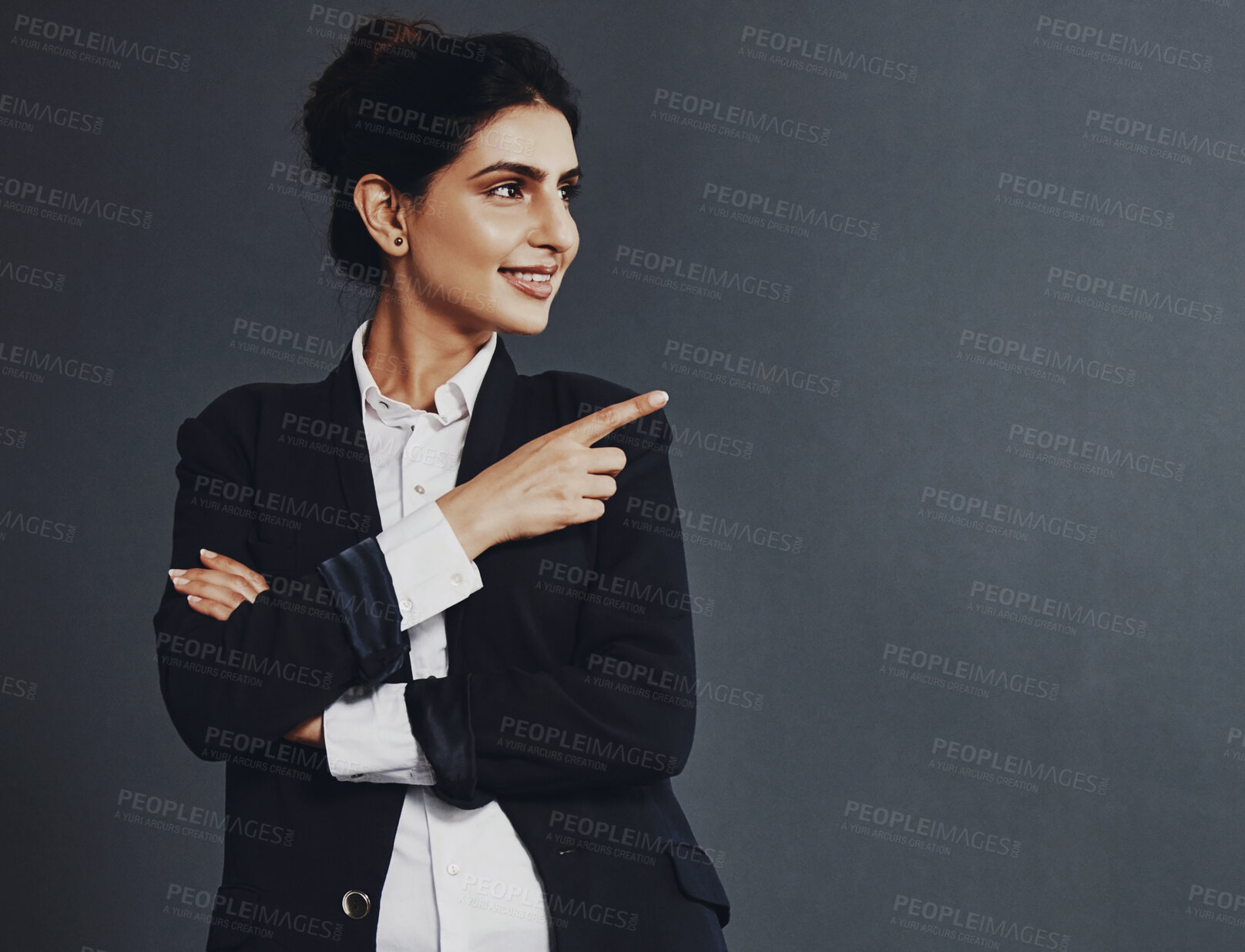 Buy stock photo Presentation, pointing and woman in studio for announcement, information or opportunity on dark background. Mockup, advice and person with gesture for notification, decision or teacher registration 