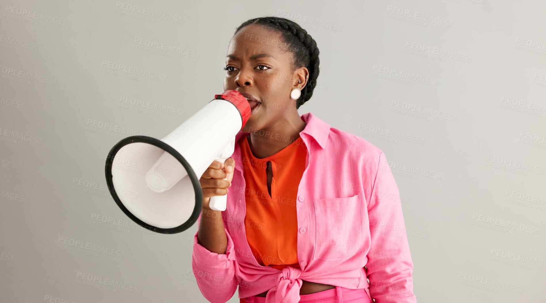 Buy stock photo Megaphone, angry and black woman on gray background for protest, revolution and rights for equality. Communication, bullhorn and person shouting for information, announcement and speech in studio