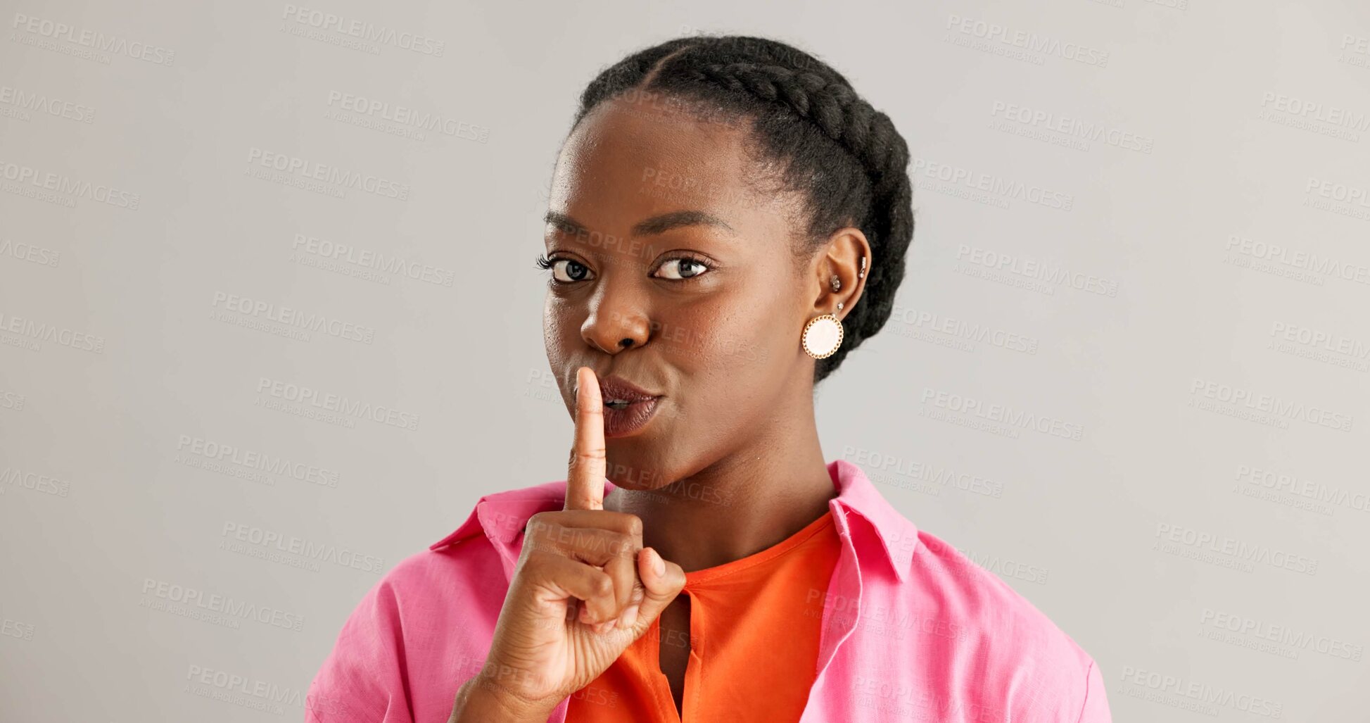 Buy stock photo Black woman, secret and smile with finger on lips for whisper or silence on a gray studio background. Portrait of happy African female person, face or looking secretive with gesture on mockup space