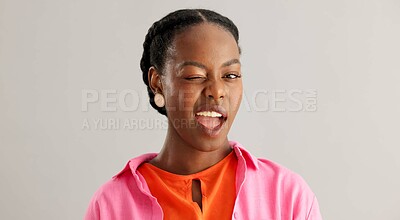 Buy stock photo Black woman, fashion and portrait with wink in studio for flirting, fun or secret on grey background. Playful, confidence and face of person with emoji for happiness, style and comic joke with smile