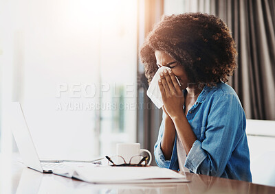 Buy stock photo Portrait of a young woman blowing her nose with a tissue while working at home