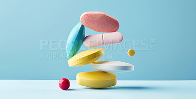 Medicine, colorful and stack of pills in studio for weightloss, recovery or sickness medication. Vitamins, healthcare and medical tablets for life extension drugs or illness by blue background.