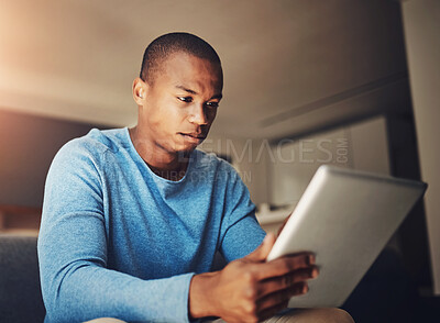 Buy stock photo Reading, tablet and man in home, serious and thinking of idea for creative thumbnail for social media. Online, concentration and internet for research of project, part time and intern of web design