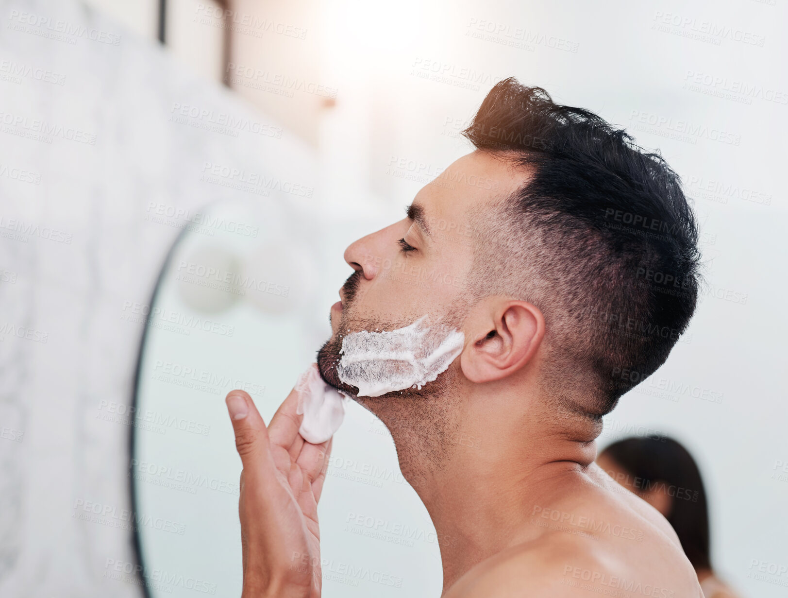 Buy stock photo Man, apply shaving foam and skincare in bathroom, cosmetics and product for hair removal. Male person, profile and treatment for hygiene or grooming in home, cream and cleaning face in routine