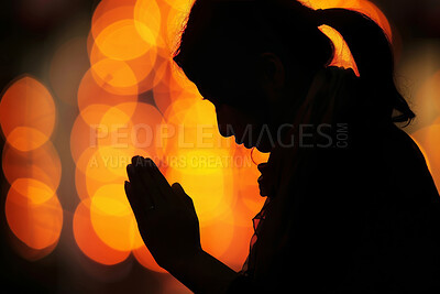 Christian, praying and silhouette of girl in church for worship, spiritual service or gospel in cathedral. Chapel lights, religion and woman with faith, belief and hope for prayer, praise or guidance