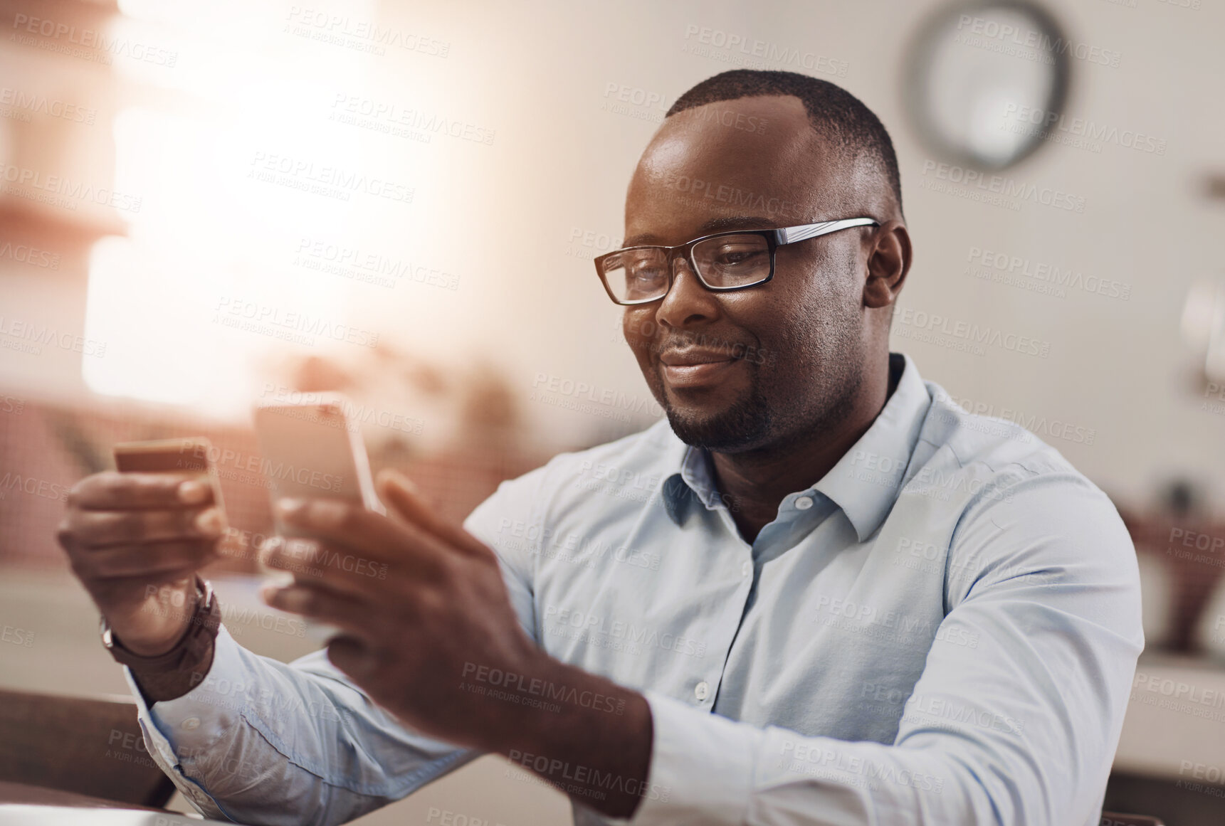 Buy stock photo Credit card, cellphone and black man in home for online payment of mortgage loan and utility bills. Phone, financial budget and African male person with internet banking app for savings account.