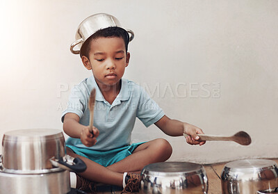 Buy stock photo Shot of an adorable little boy pretending to be a drummer with the pots at home