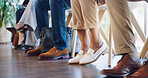 Feet, business group and job interview with nervous worker in waiting room and office. Excited, shoes and row of anxiety of people sitting in a queue for recruitment and hiring opportunity in lobby